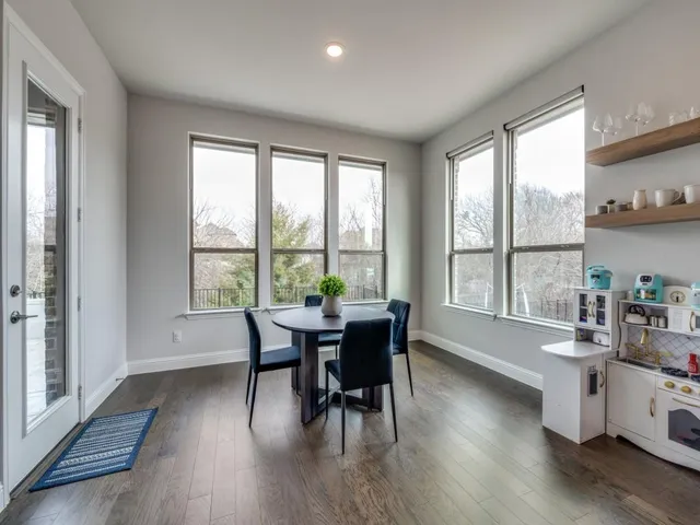 a dining room with wooden floor and furniture