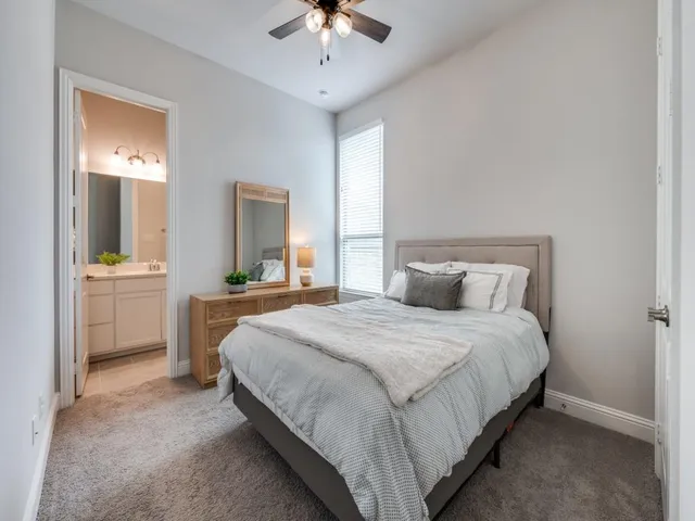 a bedroom with bed and a chandelier