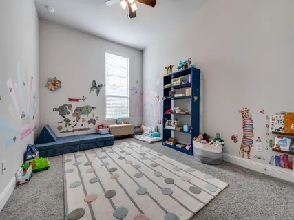 a bedroom with furniture and a book shelf
