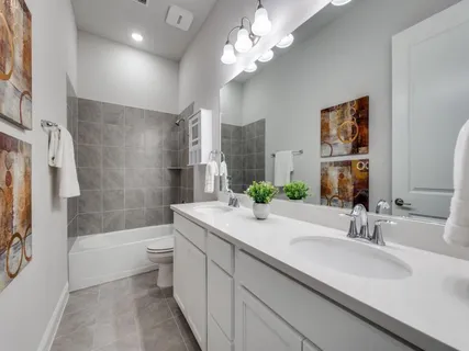 a bathroom with a sink a toilet a bathtub a mirror and shower