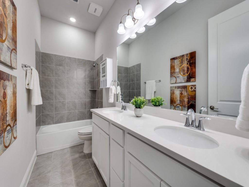 2112 Deer Run Court Gunter, TX 75058 - Photo 19 of 32 a bathroom with a sink a toilet a bathtub a mirror and shower