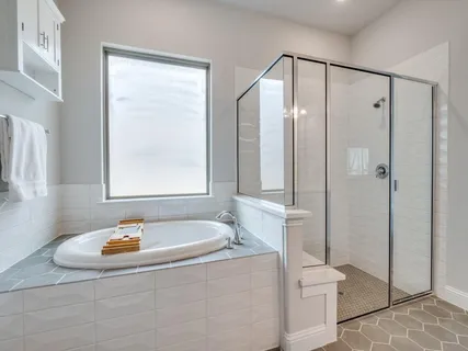 a bathroom with a tub a toilet and a shower