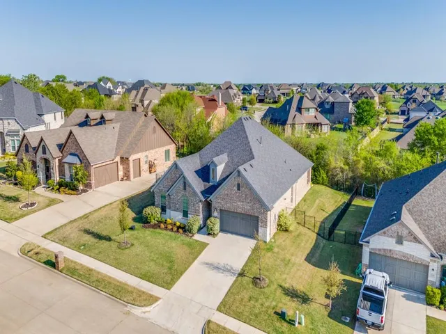 an aerial view of a house with a garden and outdoor seating