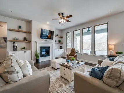 a living room with furniture a flat screen tv and a fireplace