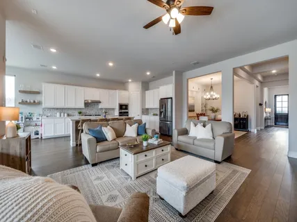 a living room with furniture and kitchen view