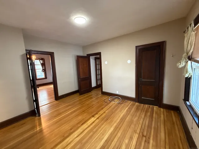 a view of a room with wooden floor and stairs