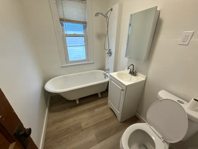 a bathroom with a sink a toilet and tub