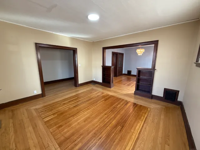 a view of a room with wooden floor and furniture