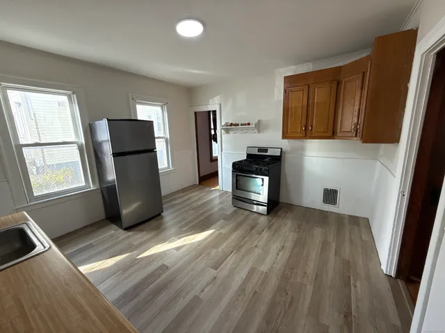 a view of kitchen with furniture and wooden floor