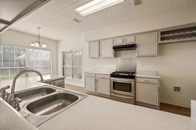 a kitchen with a sink cabinets and stainless steel appliances