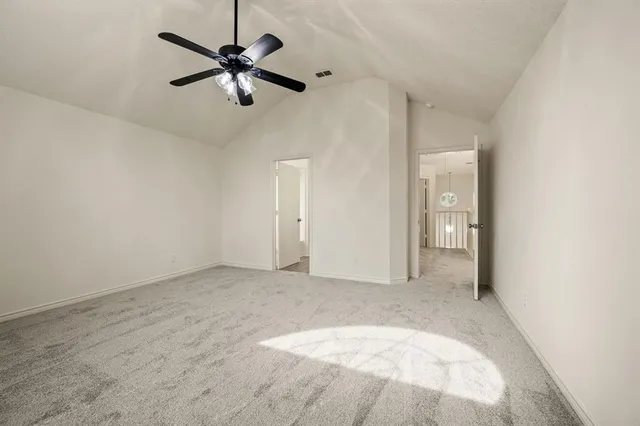 an empty room with fan and ceiling fan