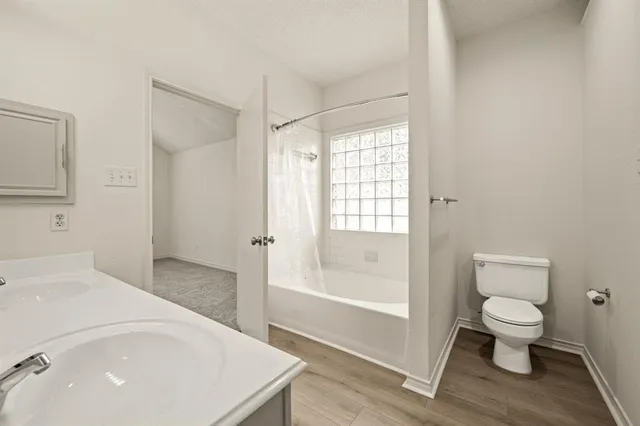 a bathroom with a toilet a sink and bathtub