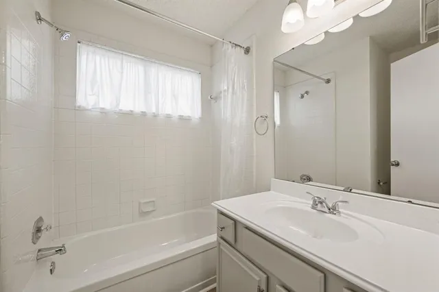a bathroom with a bathtub and a sink