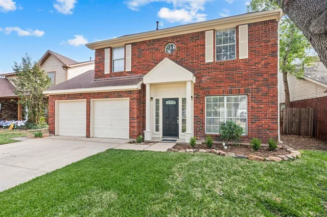 a front view of a house with a yard and outdoor seating
