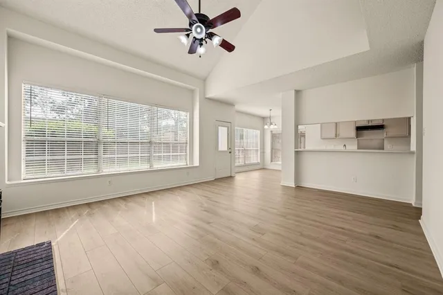 a view of a kitchen with a dishwasher cabinets and wooden floor