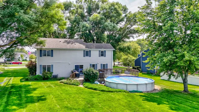 a view of a house with a backyard and a tree
