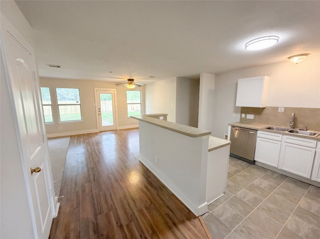 414 Binnacle Way Crosby, TX 77532 - Photo 11 of 22 a kitchen with cabinets and wooden floor