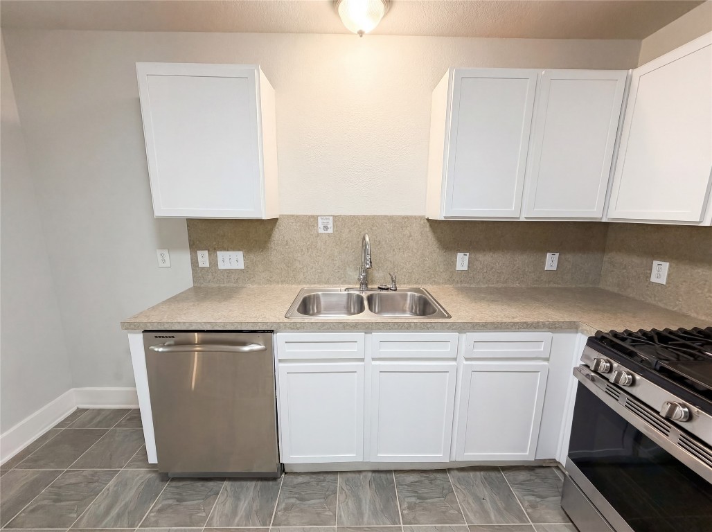 414 Binnacle Way Crosby, TX 77532 - Photo 15 of 22 a kitchen with a stove sink and cabinets