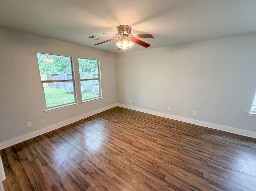 414 Binnacle Way Crosby, TX 77532 - Photo 19 of 22 a view of an empty room with wooden floor and a window
