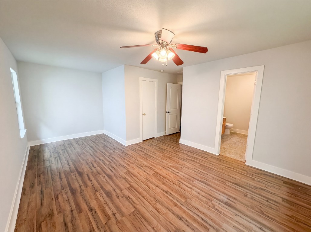 414 Binnacle Way Crosby, TX 77532 - Photo 20 of 22 a view of an empty room with wooden floor and a ceiling fan