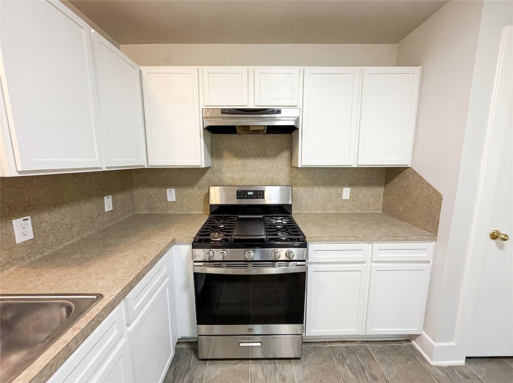 414 Binnacle Way Crosby, TX 77532 - Photo 2 of 22 a kitchen with granite countertop a stove and a sink