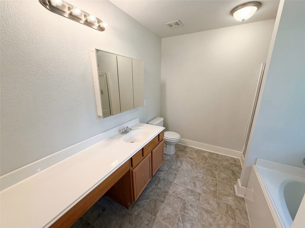 414 Binnacle Way Crosby, TX 77532 - Photo 21 of 22 a bathroom with a sink a toilet and mirror