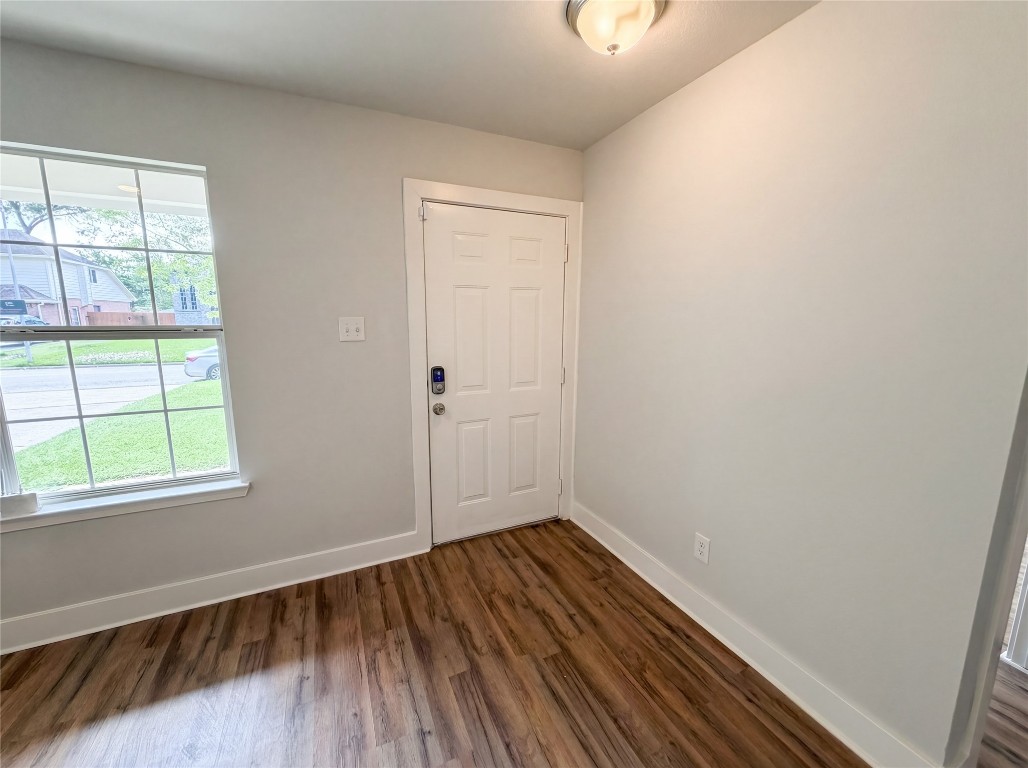 414 Binnacle Way Crosby, TX 77532 - Photo 9 of 22 an empty room with wooden floor and windows