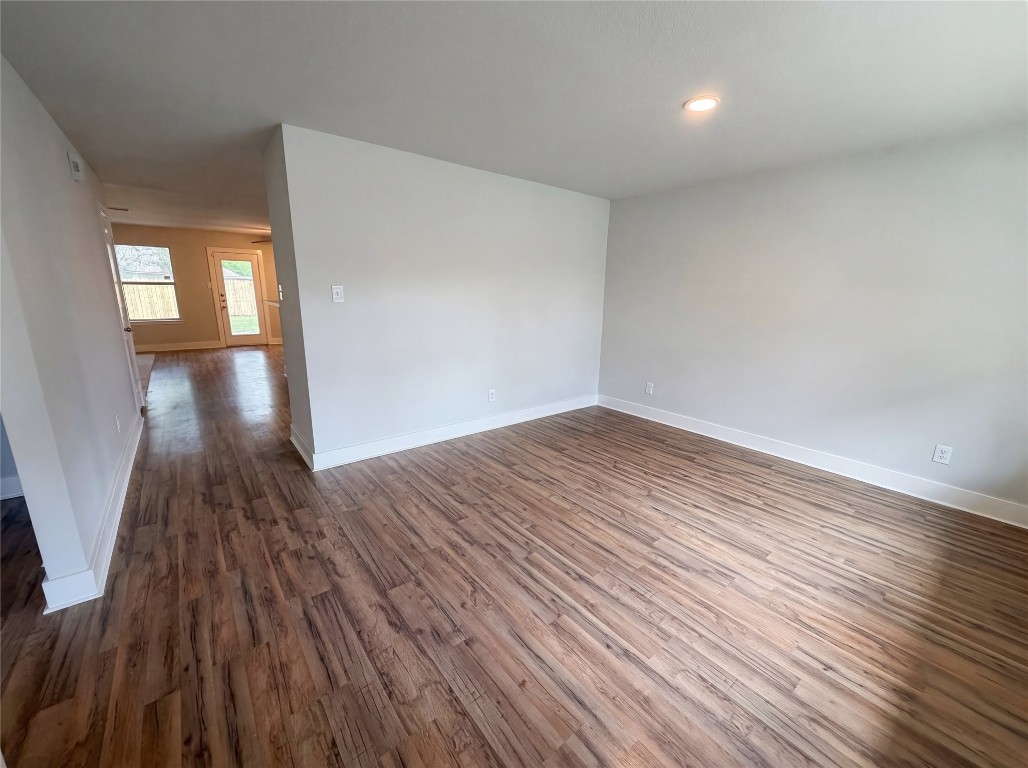 414 Binnacle Way Crosby, TX 77532 - Photo 10 of 22 wooden floor in an empty room with a window