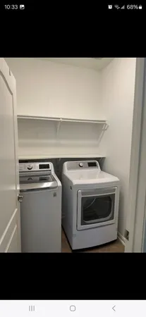 a kitchen with stainless steel appliances granite countertop a stove a sink and white cabinets