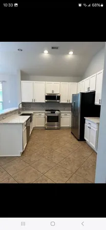 a view of kitchen with refrigerator sink and microwave