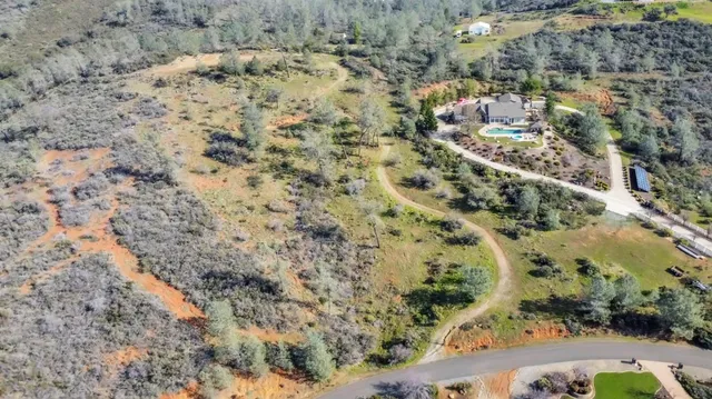 a view of a yard with wooden fence