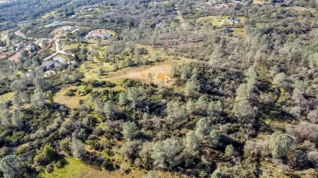 a view of a field with trees around
