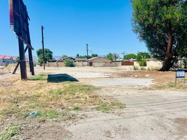 a view of a yard with a table and chairs