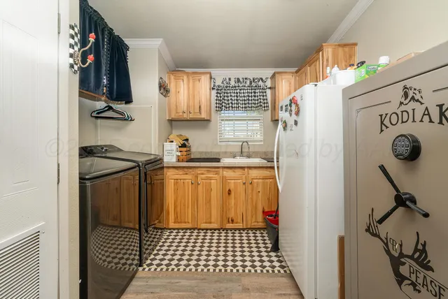 a kitchen with a refrigerator and a stove