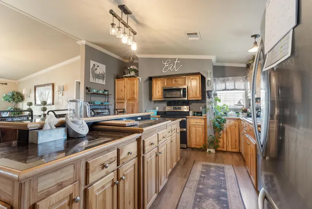 a kitchen with a sink refrigerator and microwave