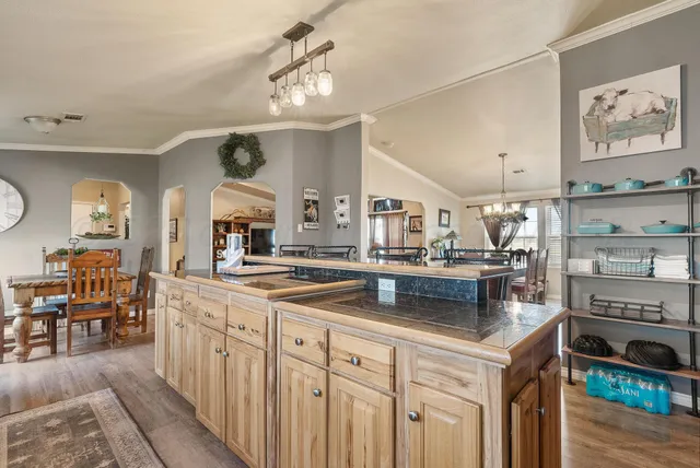 a kitchen with stainless steel appliances a sink stove and cabinets