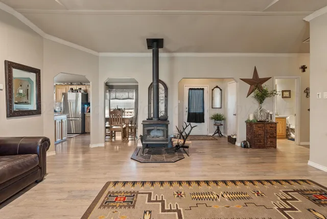 a living room with fireplace furniture and a wooden floor