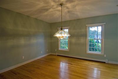 455 Mistic Drive Marstons Mills, MA 02648 - Photo 7 of 16 an empty room with wooden floor chandelier and windows