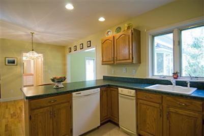 455 Mistic Drive Marstons Mills, MA 02648 - Photo 9 of 16 a kitchen with granite countertop a sink and white cabinets