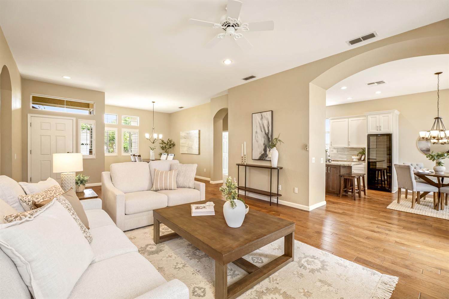 4081 Rose Creek Road Roseville, CA 95747 - Photo 13 of 52 a living room with couches a coffee table and kitchen view with wooden floor
