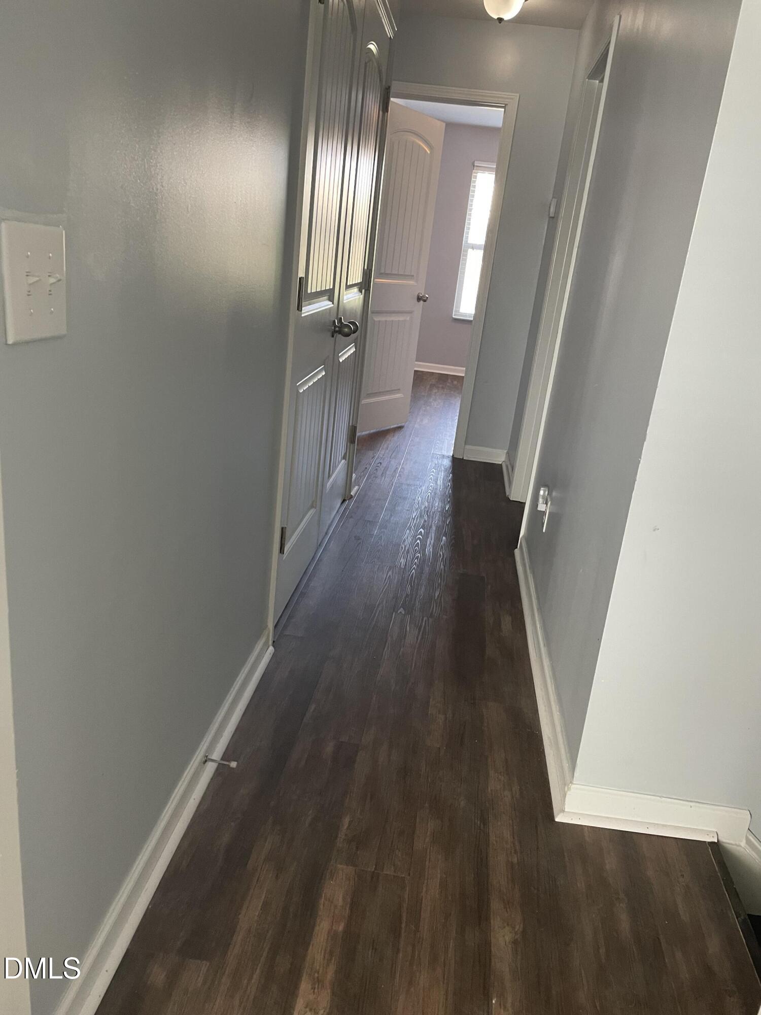 4438 Hillsgrove Road Wake Forest, NC 27587 - Photo 14 of 16 a view of a hallway with wooden floor and staircase