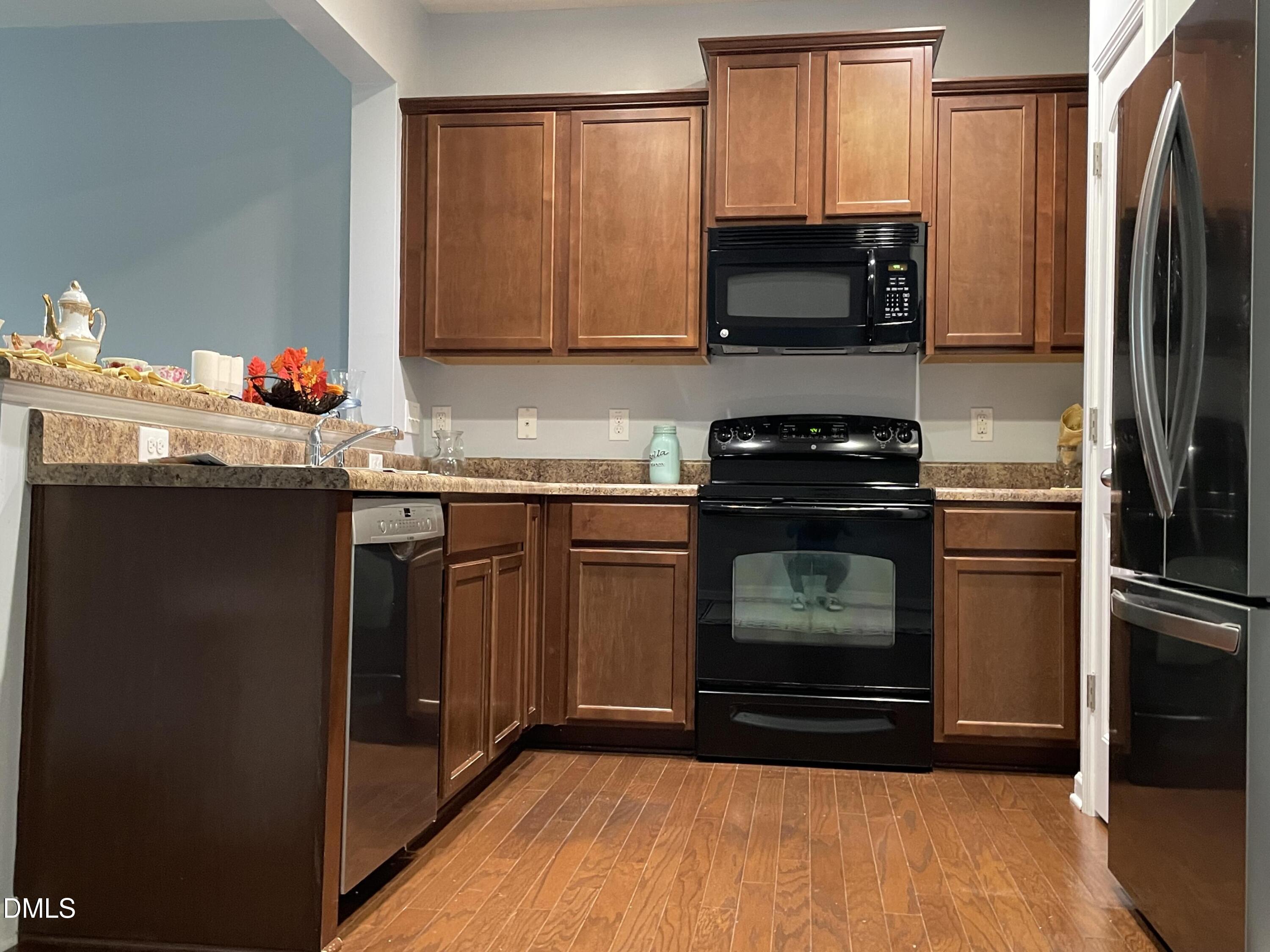 4438 Hillsgrove Road Wake Forest, NC 27587 - Photo 4 of 16 a kitchen with granite countertop a stove top oven and cabinets