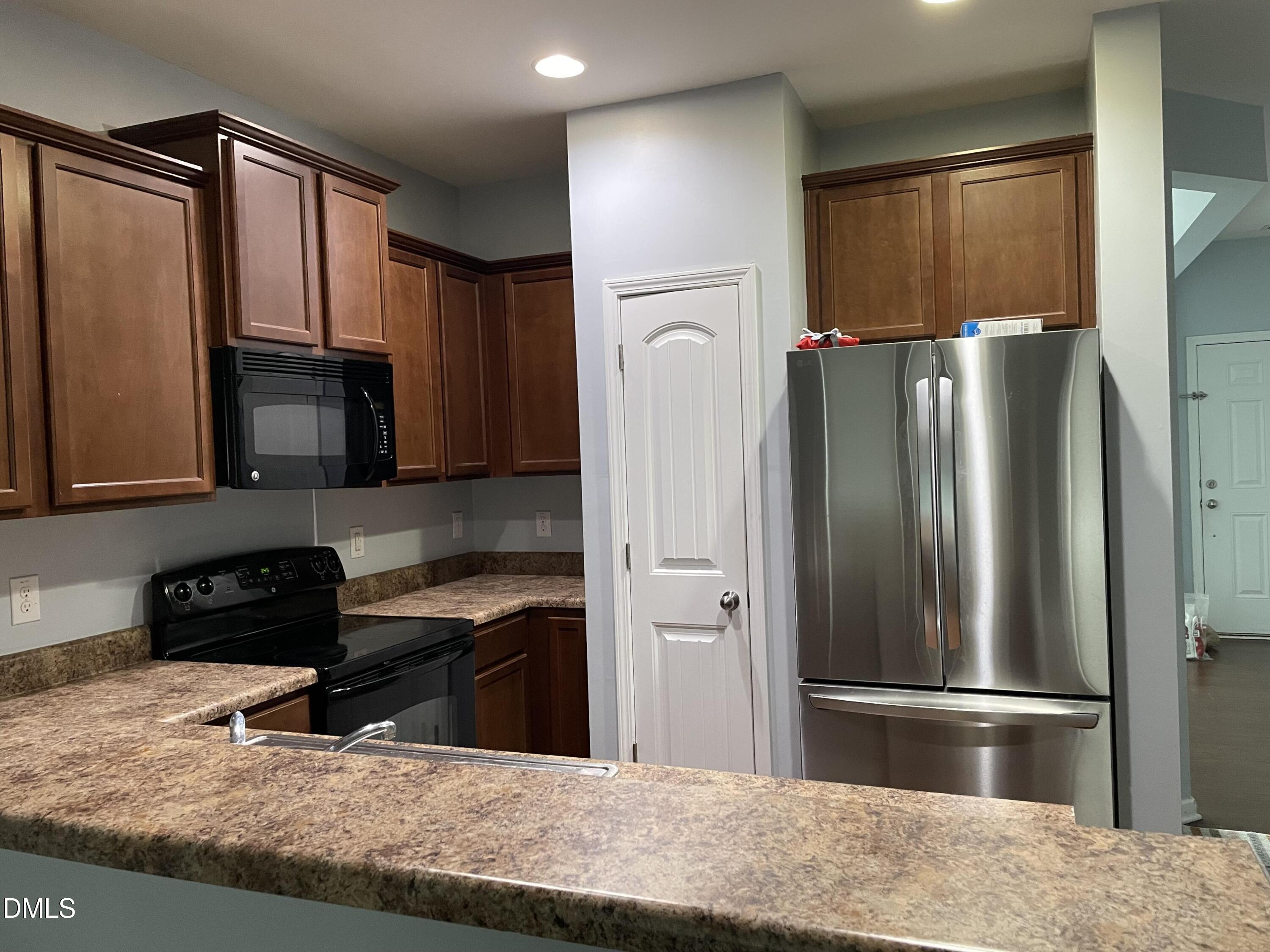 4438 Hillsgrove Road Wake Forest, NC 27587 - Photo 6 of 16 a kitchen with granite countertop a refrigerator and a sink