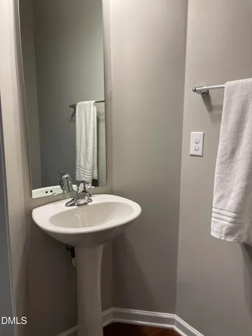 a bathroom with a sink a mirror and vanity