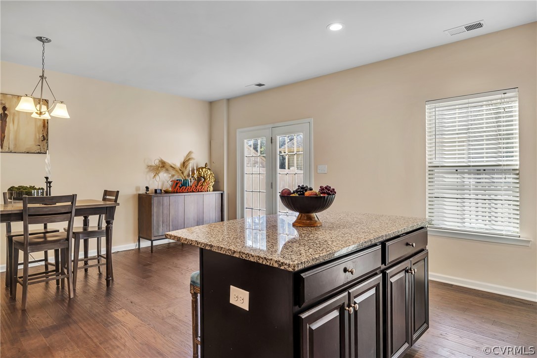 5724 Riverside Place Richmond, VA 23225 - Photo 17 of 47 a kitchen with granite countertop kitchen island stainless steel appliances a table chairs sink and living room view