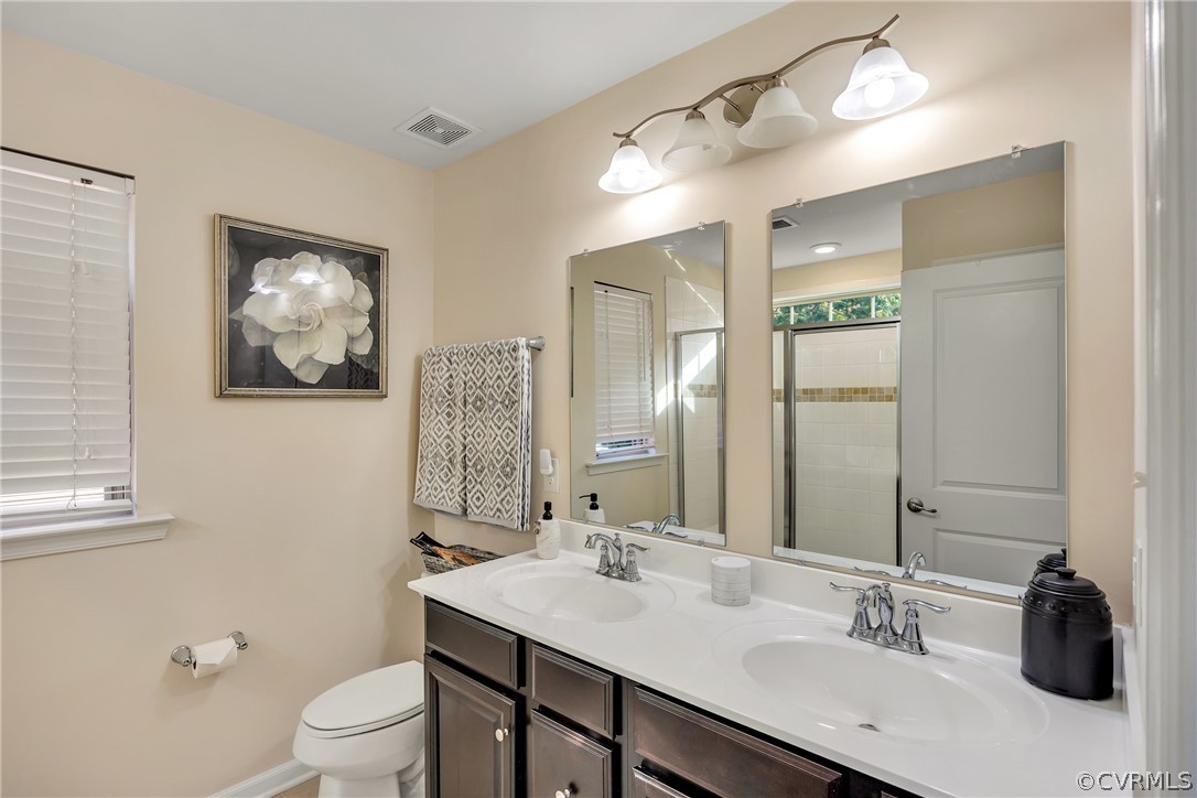 5724 Riverside Place Richmond, VA 23225 - Photo 28 of 47 a bathroom with a sink vanity and a mirror