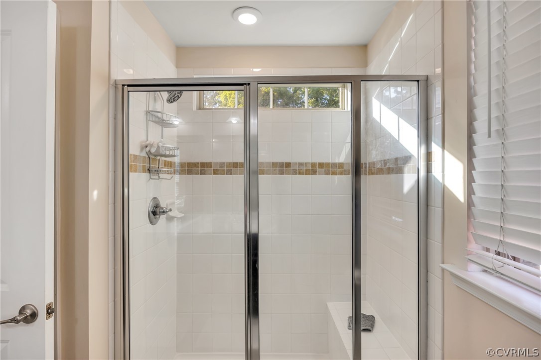 5724 Riverside Place Richmond, VA 23225 - Photo 29 of 47 a bathroom with a glass shower door