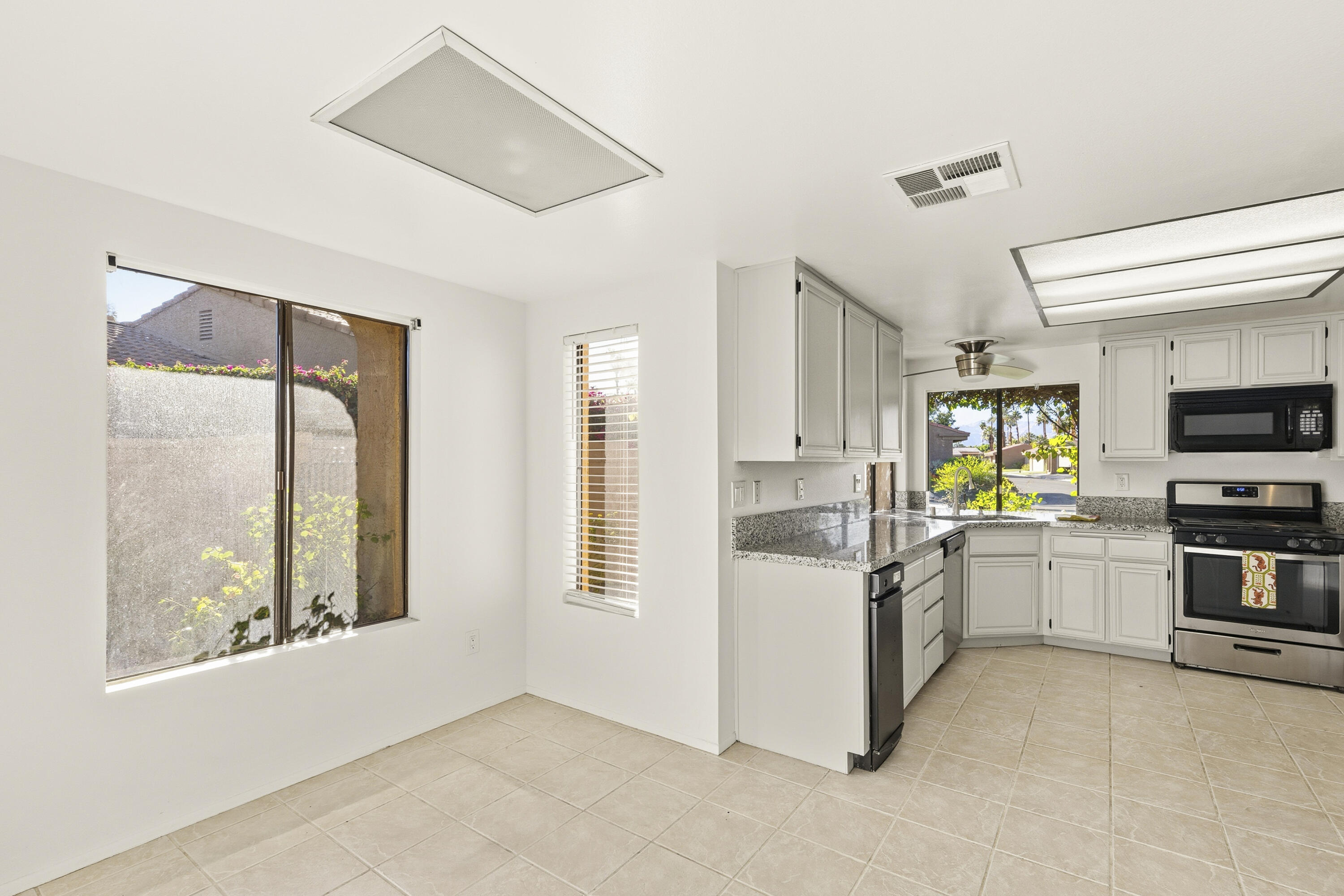 44695 Monaco Circle Palm Desert, CA 92260 - Photo 15 of 58 a kitchen with a stove a refrigerator and a stove top oven