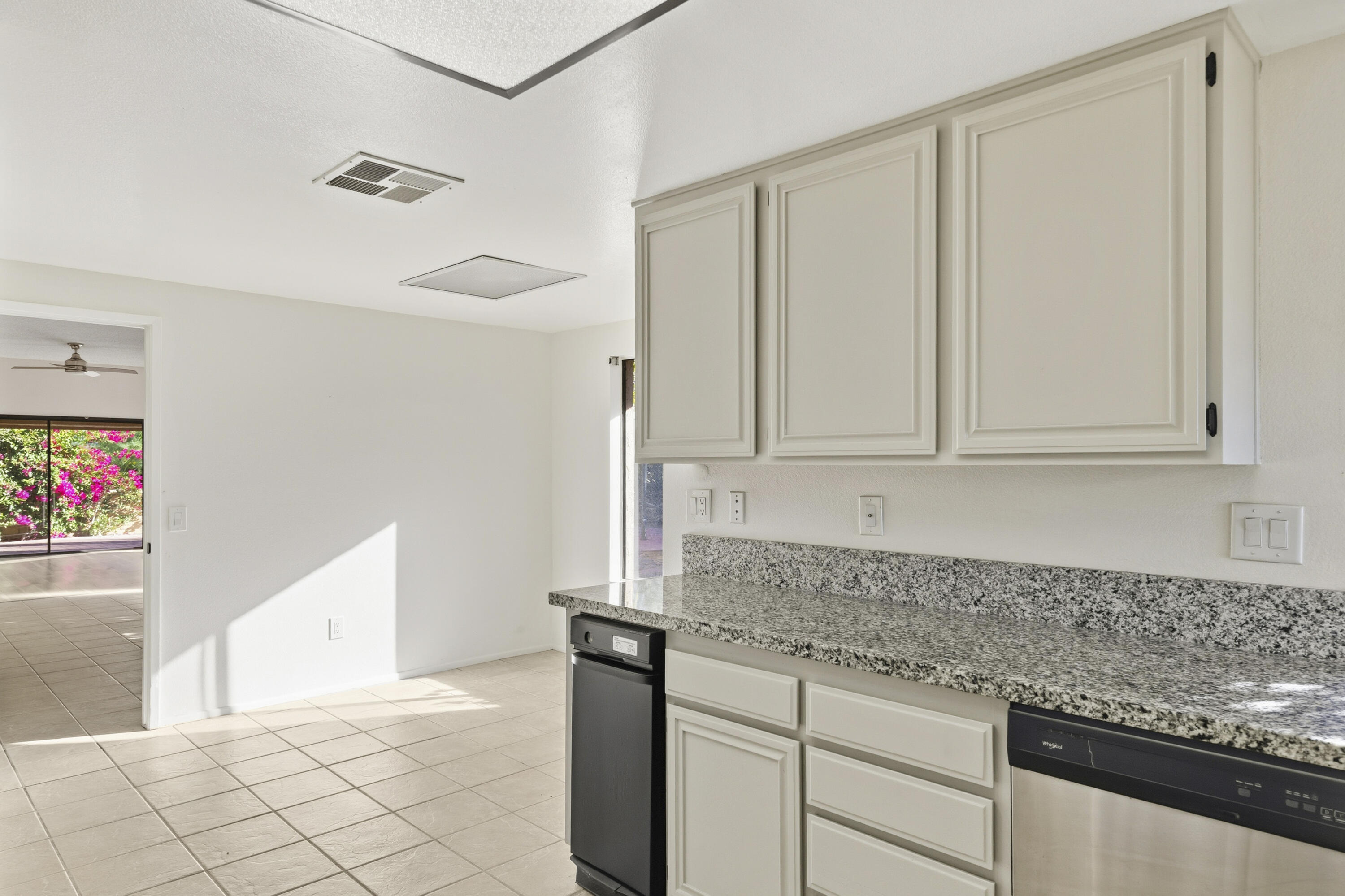 44695 Monaco Circle Palm Desert, CA 92260 - Photo 18 of 58 a kitchen with granite countertop white cabinets and sink