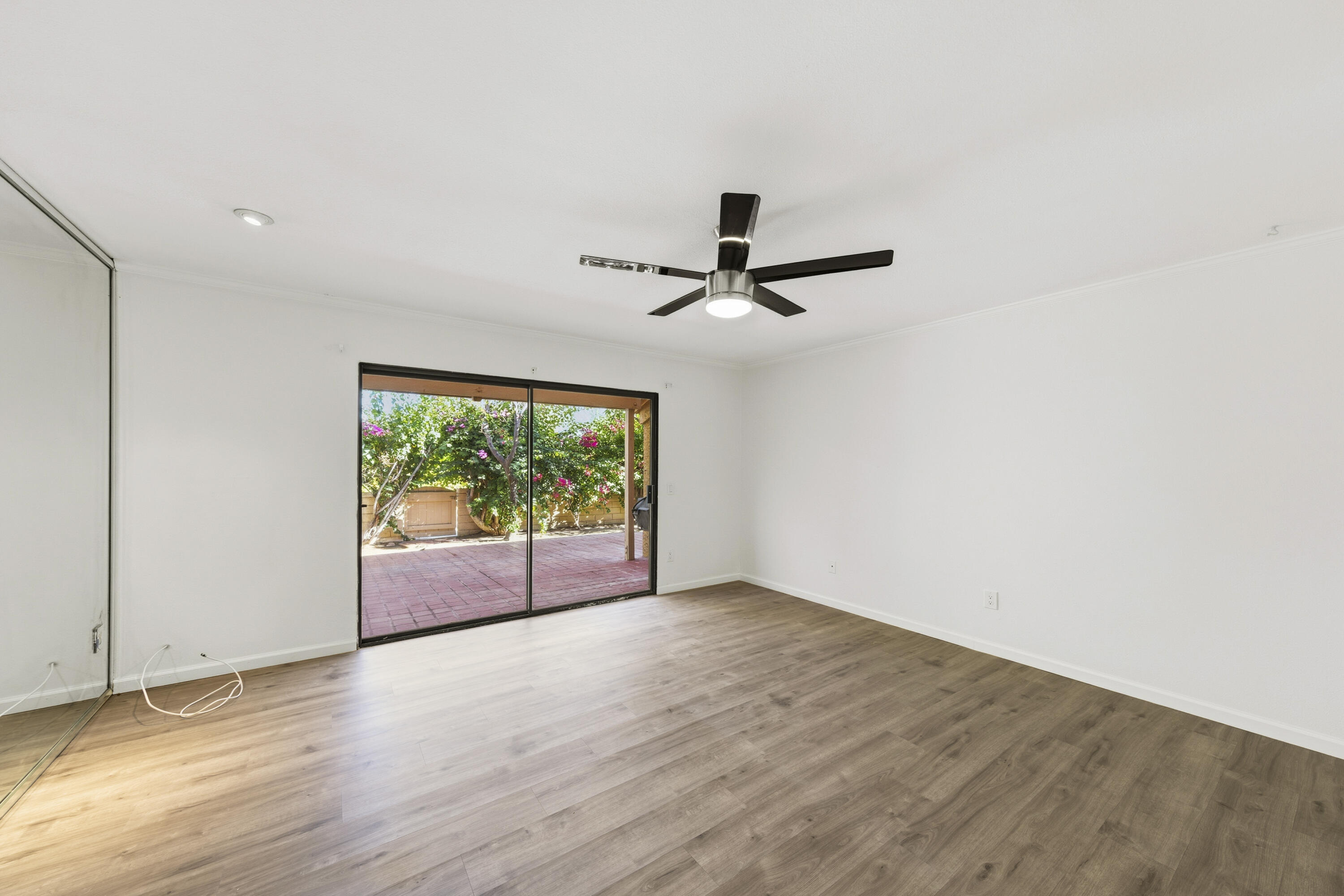 44695 Monaco Circle Palm Desert, CA 92260 - Photo 19 of 58 a view of empty room with wooden floor and fan
